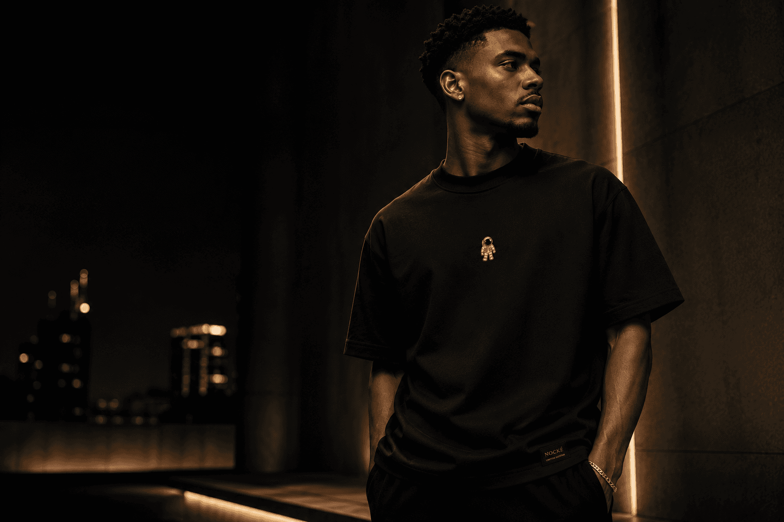 Model wearing a black NOCKÉ tee in a night editorial campaign